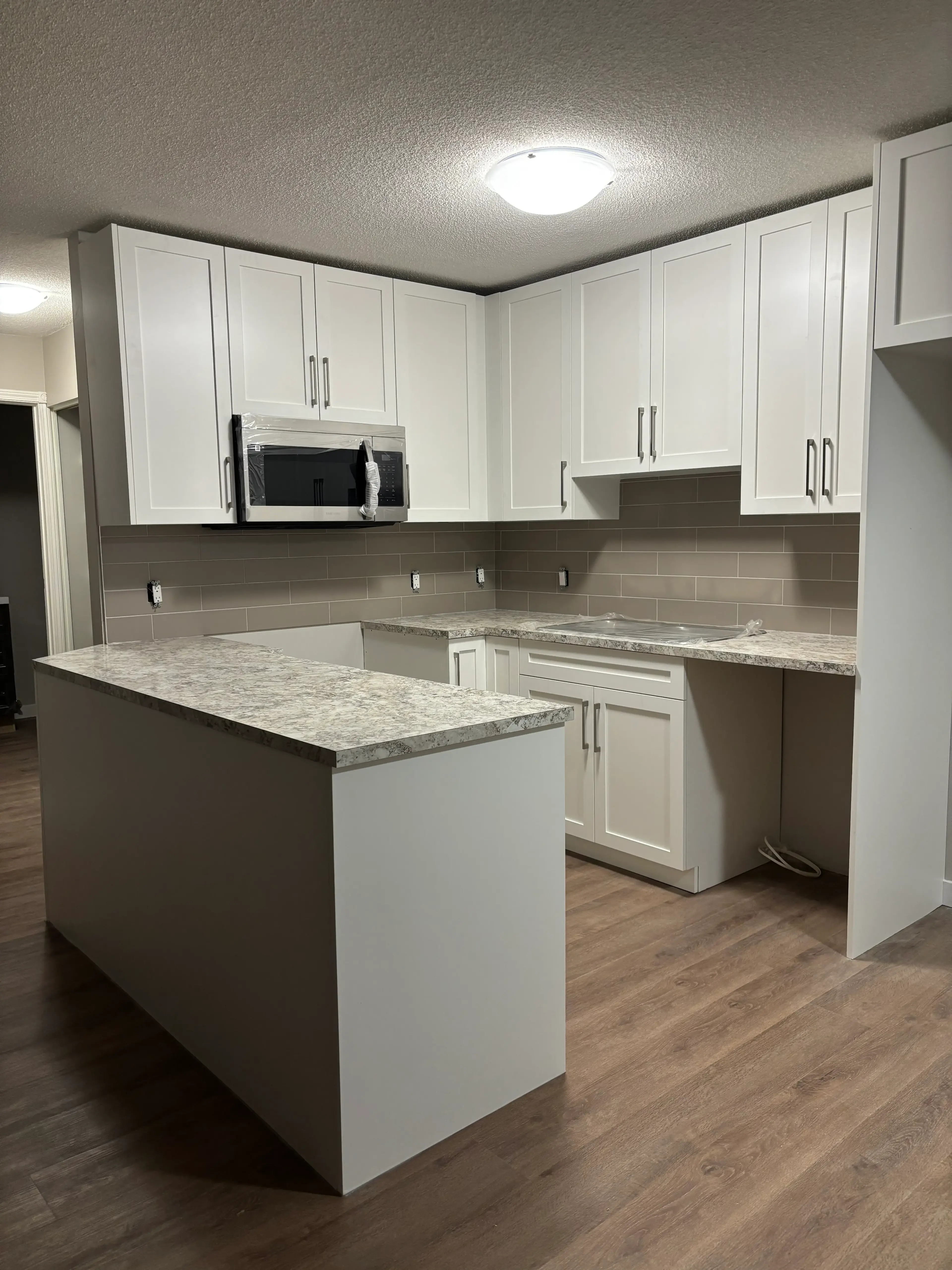 White Kitchen with Marble Counters - Calgary trade millwork project by Rocky Mountain Millwork